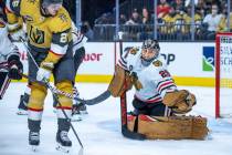 Golden Knights center Mattias Janmark (26) sends a puck towards the net defended by Chicago Bla ...