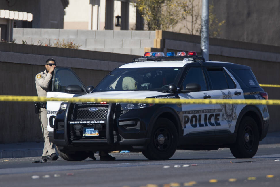 Las Vegas police investigate the scene of an officer-involved shooting near the intersection of ...