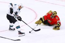 Golden Knights goaltender Marc-Andre Fleury (29) poke checks the puck away from San Jose Sharks ...