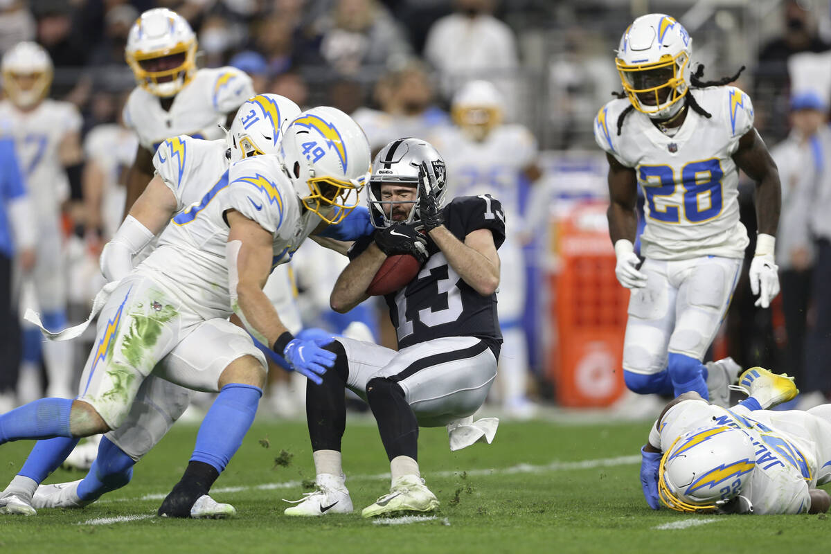 Los Angeles Chargers middle linebacker Drue Tranquill (49) tackles Las Vegas Raiders wide recei ...