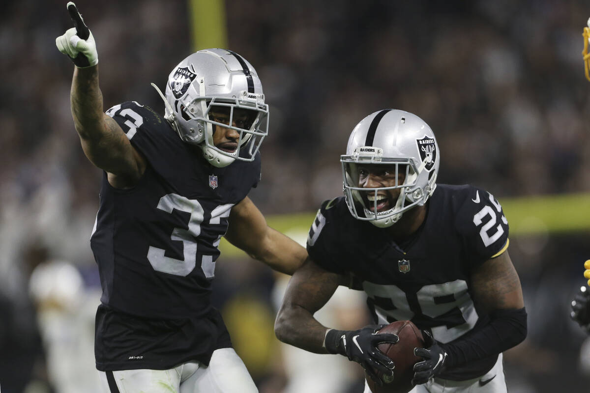 Las Vegas Raiders safety Roderic Teamer (33) celebrates after cornerback Casey Hayward, right, ...