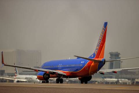 A Southwest Airlines plane prepares to take off as others move along the tarmac at McCarran Int ...