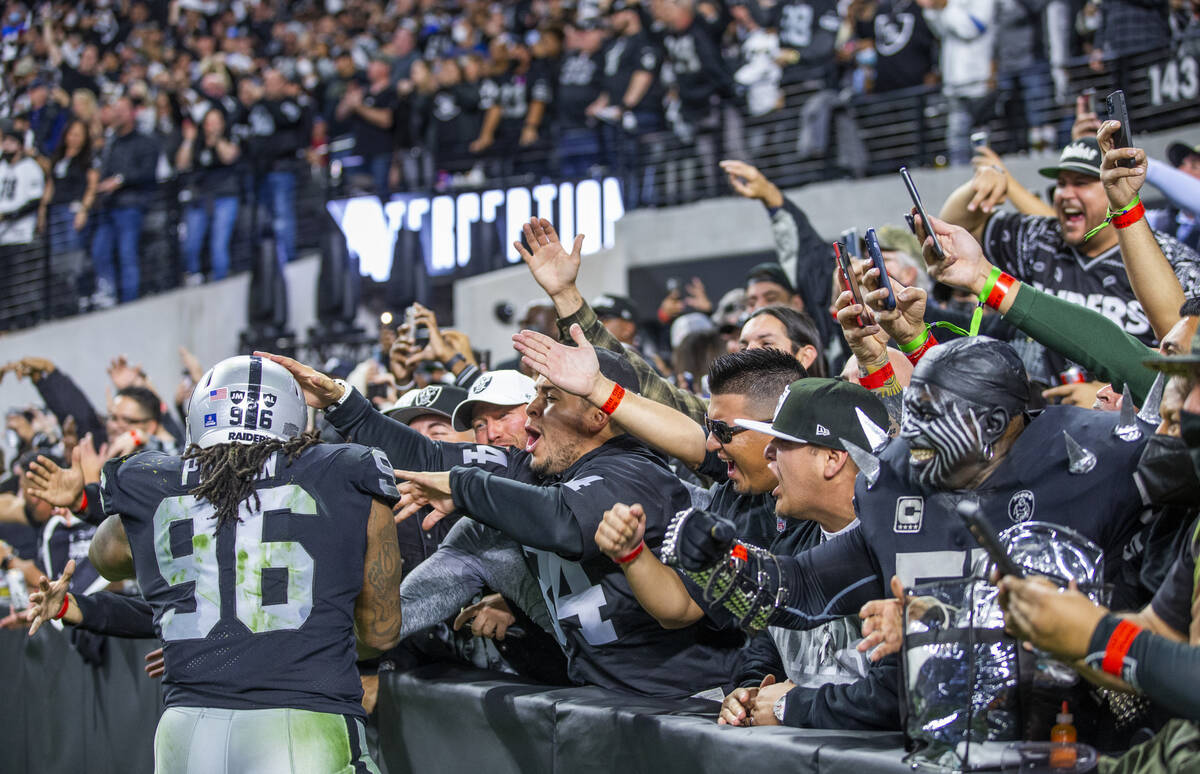 Raiders defensive tackle Darius Philon (96) celebrates a team interception with the fans versus ...