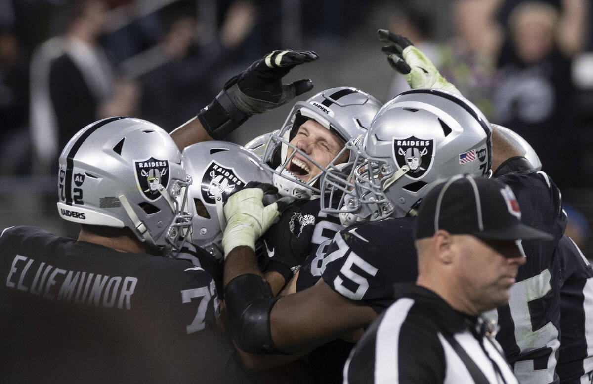 Raiders kicker Daniel Carlson, top/middle, celebrates after kicking the game winning field goal ...