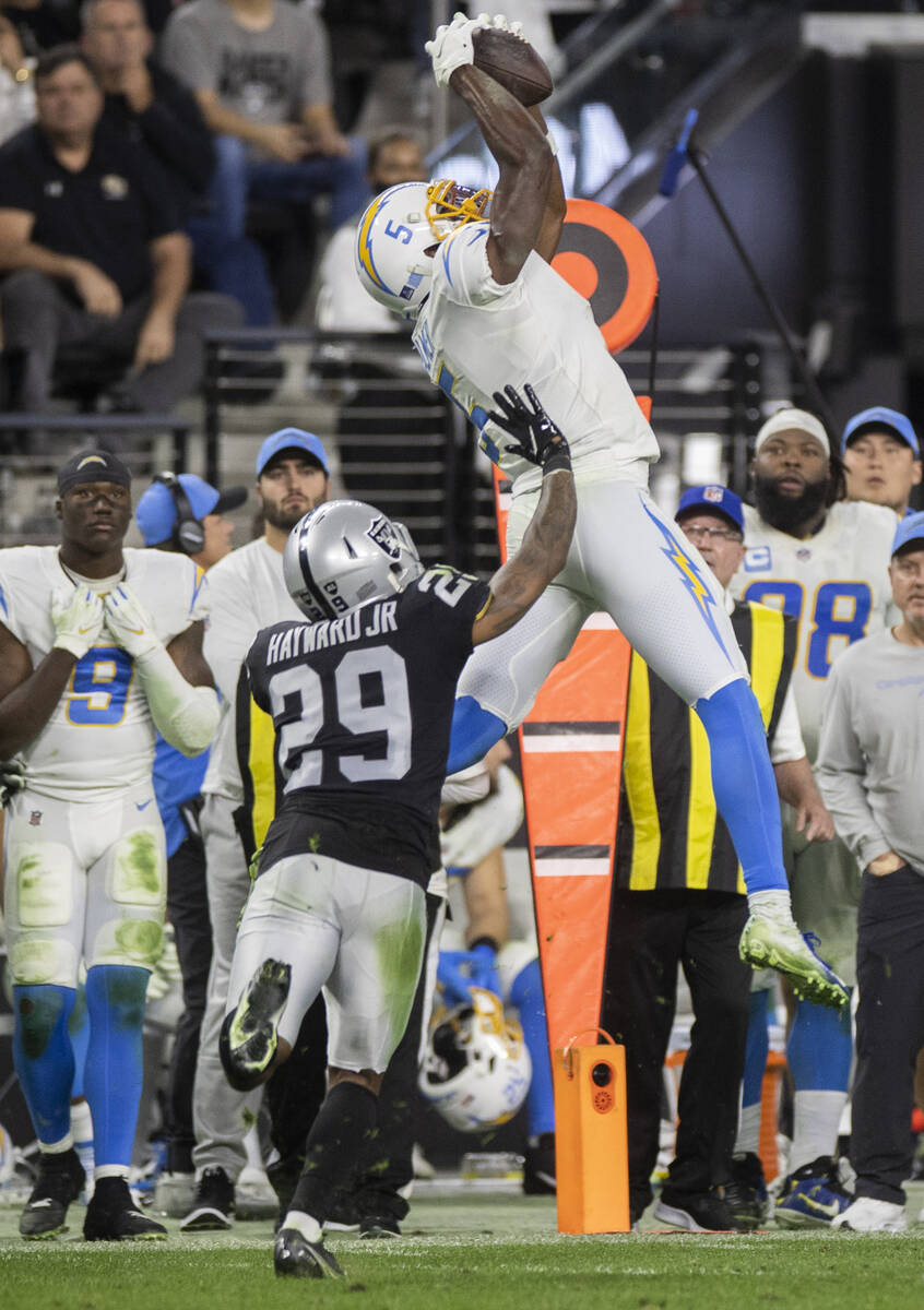 Los Angeles Chargers wide receiver Josh Palmer (5) leaps to make a catch over Raiders cornerbac ...