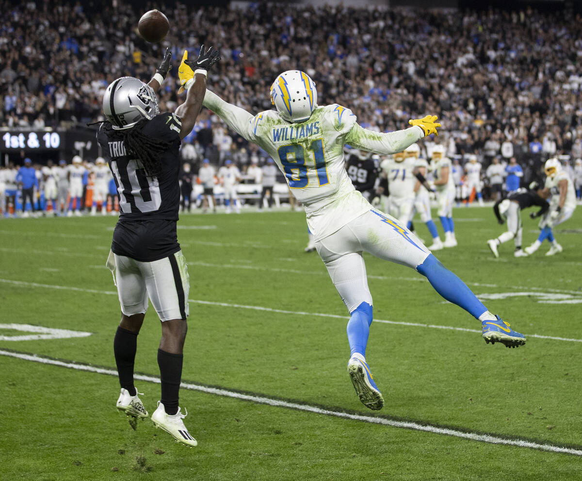 Los Angeles Chargers wide receiver Mike Williams (81) fights for a catch with Raiders cornerbac ...