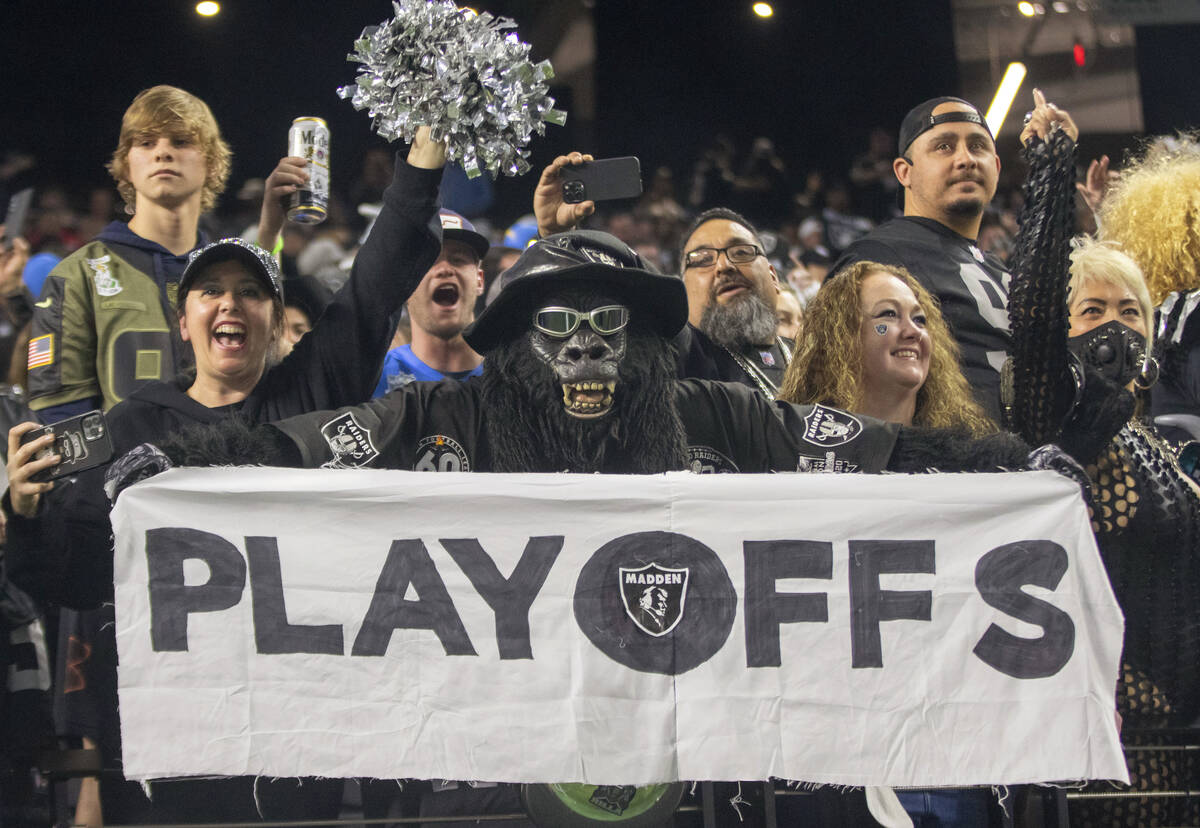 Raiders superfan Gorilla Rilla holds up a playoffs sign in the Black Hole after the team beat t ...
