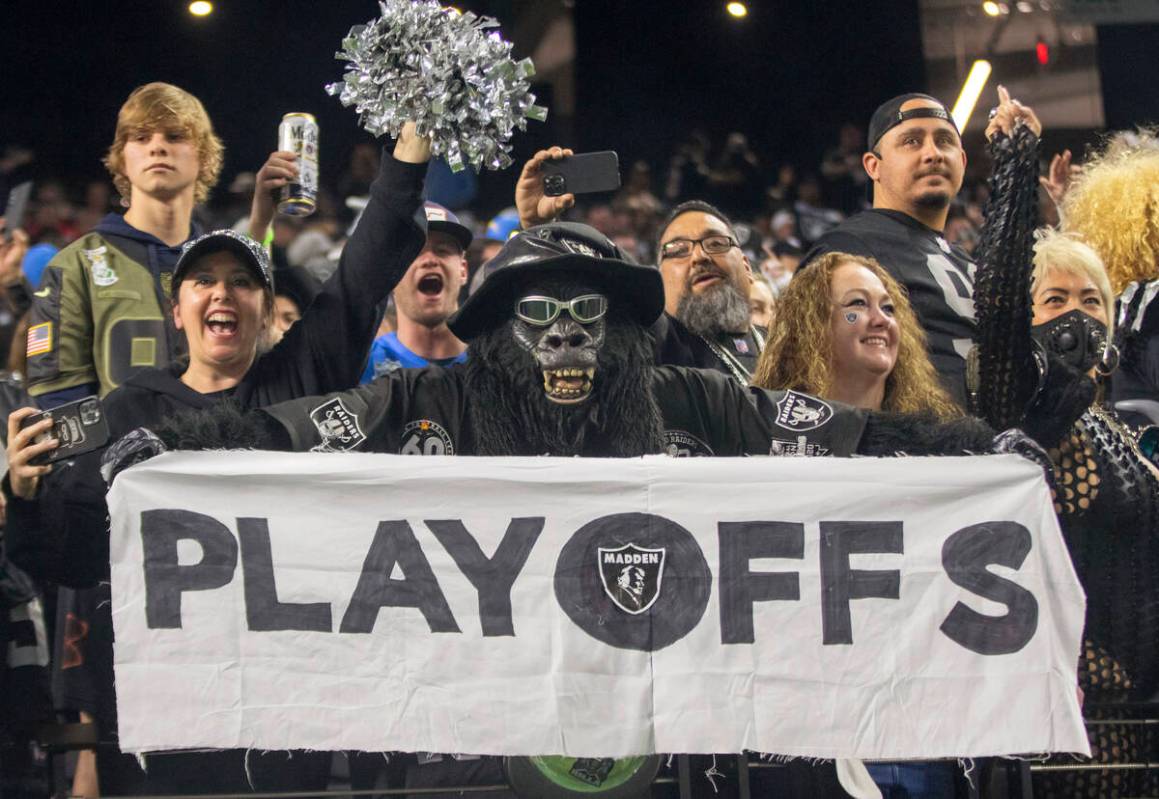 Raiders superfan Gorilla Rilla holds up a playoffs sign in the Black Hole after the team beat t ...