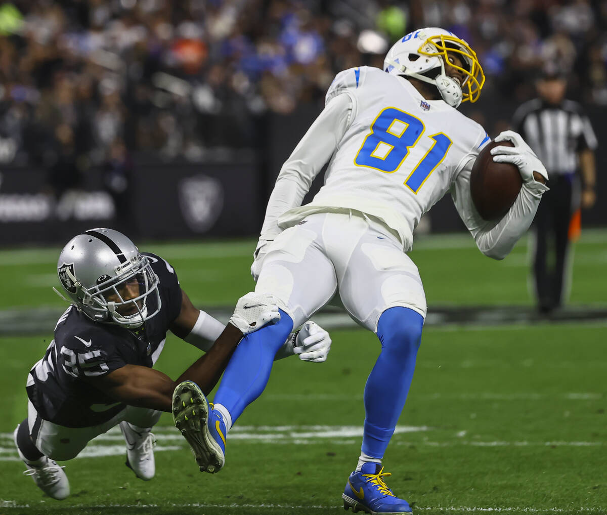 Raiders cornerback Brandon Facyson (35) tackles Los Angeles Chargers wide receiver Mike William ...