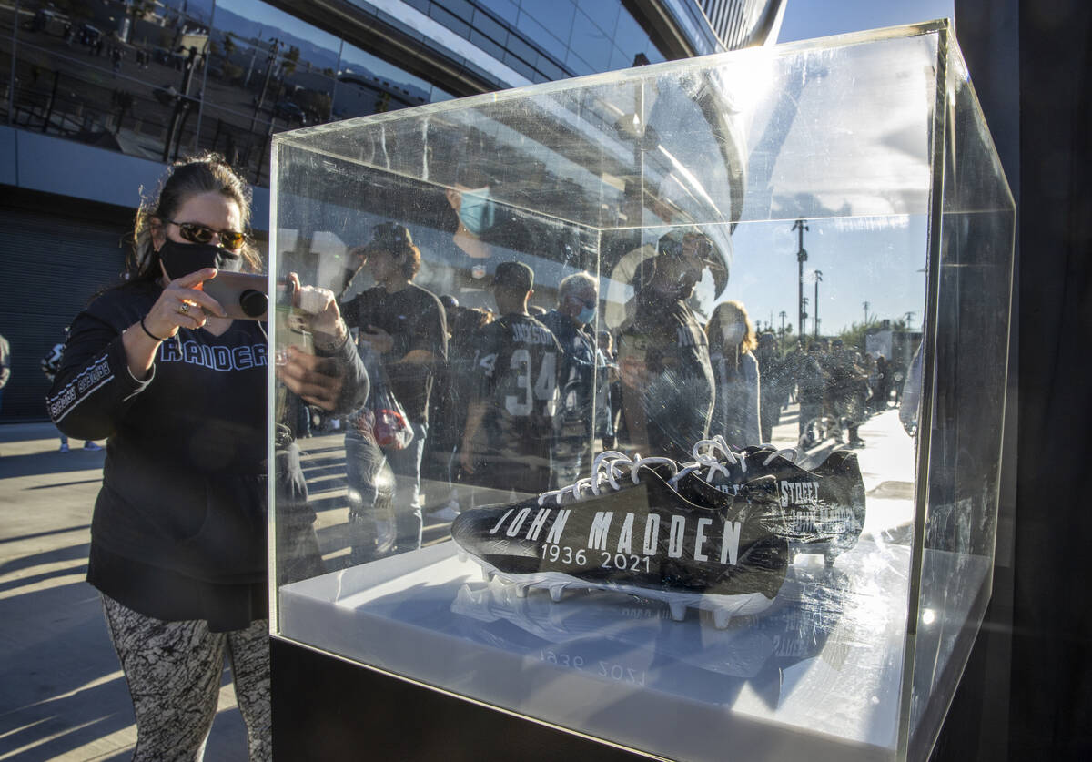 Custom John Madden cleats are apart of a memorial display for the coach before the first half o ...
