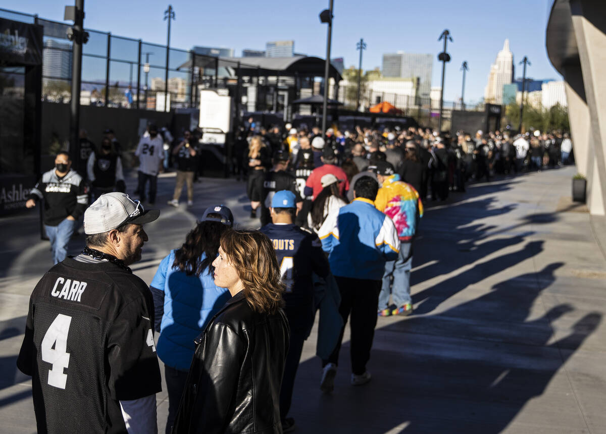 Raiders fans wait in line to see the Madden cruiser before the start of an NFL football game ag ...