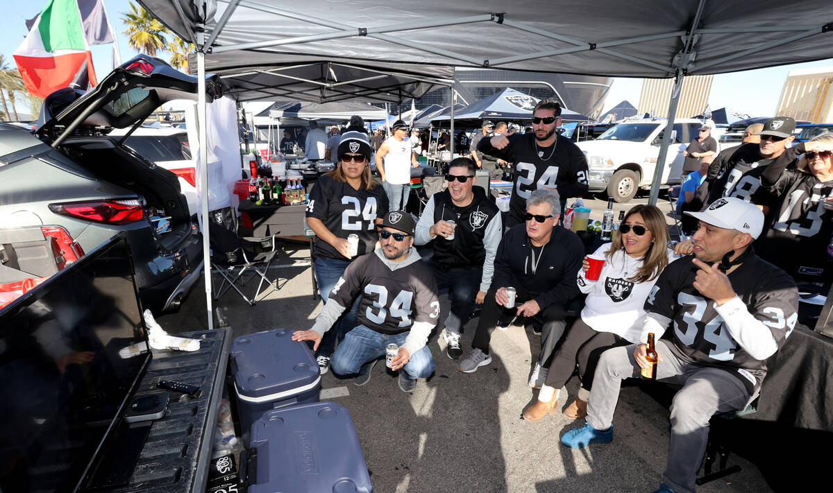Fans in tailgate lot J watch the final seconds of the Ravens Steelers game before the Raiders t ...