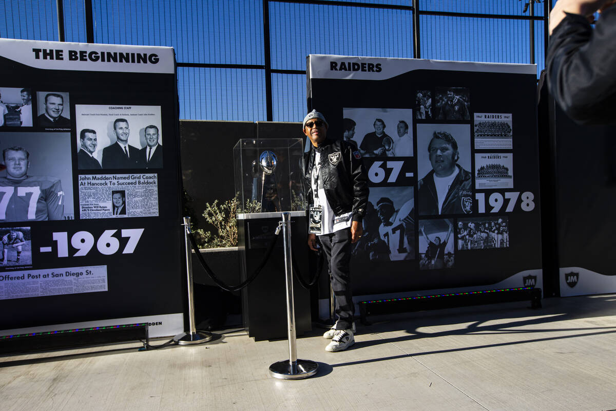 David Humdy. of Las Vegas, poses with a display of John Madden memorabilia, including the Vince ...