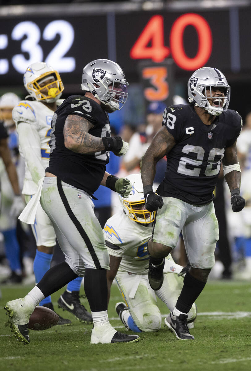 Raiders running back Josh Jacobs (28) celebrates after after making a big run in overtime duri ...