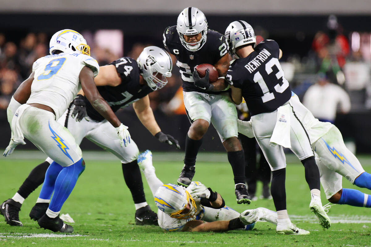 Raiders running back Josh Jacobs (28) runs the ball against the Los Angeles Chargers in overtim ...