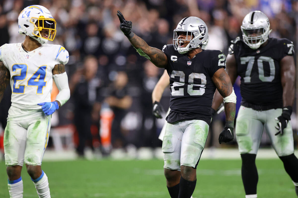 Raiders running back Josh Jacobs (28) reacts after his first down run in overtime during an NFL ...
