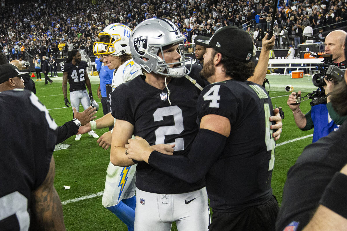 Raiders kicker Daniel Carlson (2) and Raiders quarterback Derek Carr (4) celebrate after the te ...
