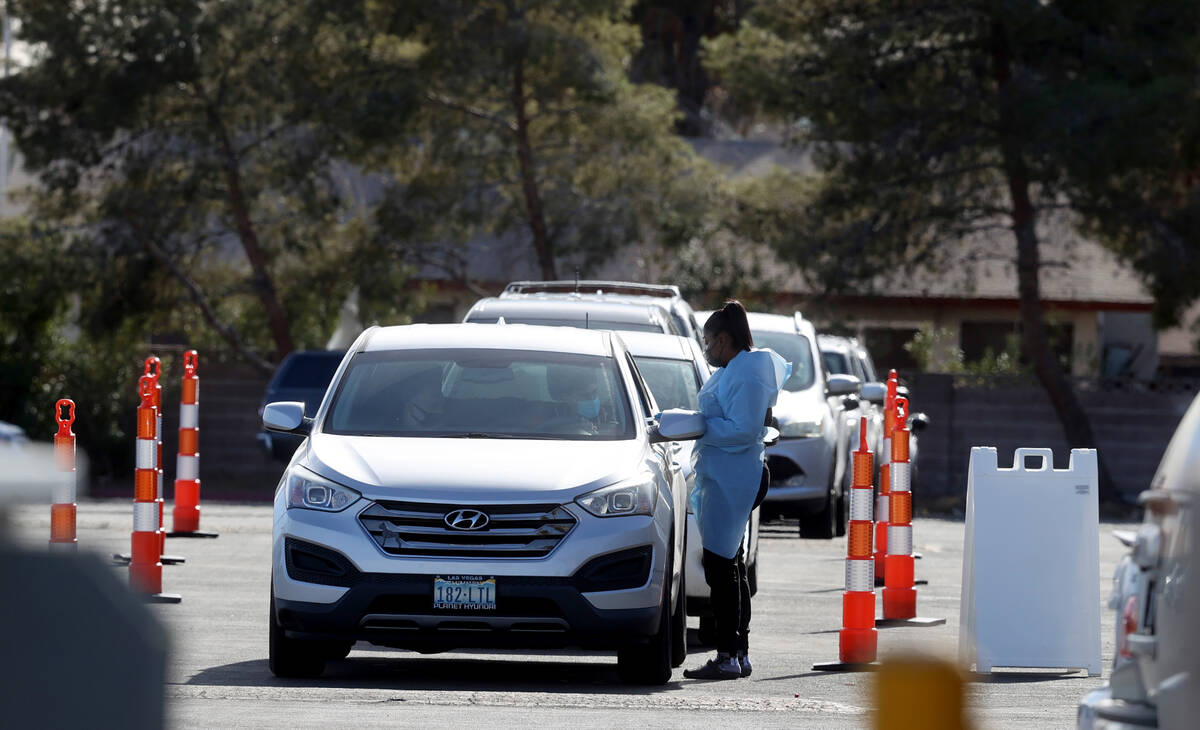 Cars line up for COVID-19 testing at the YMCA on Meadows Lane in Las Vegas Monday, Jan. 10, 202 ...