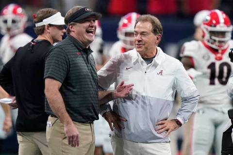 FILE - Georgia head coach Kirby Smart speaks with Alabama head coach Nick Saban before the firs ...