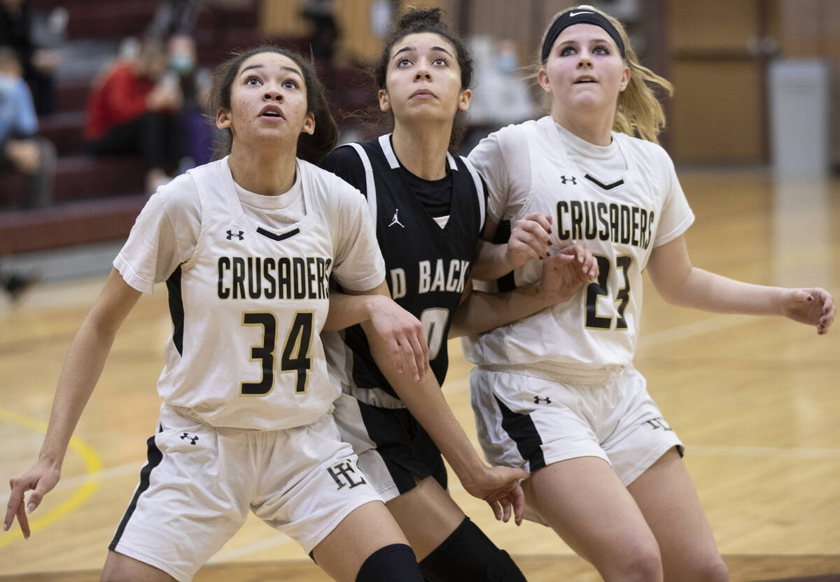 Faith Lutheran’s Leah Mitchell (34) and Raina Forgue (23) container  retired  Desert Oasis’ O ...