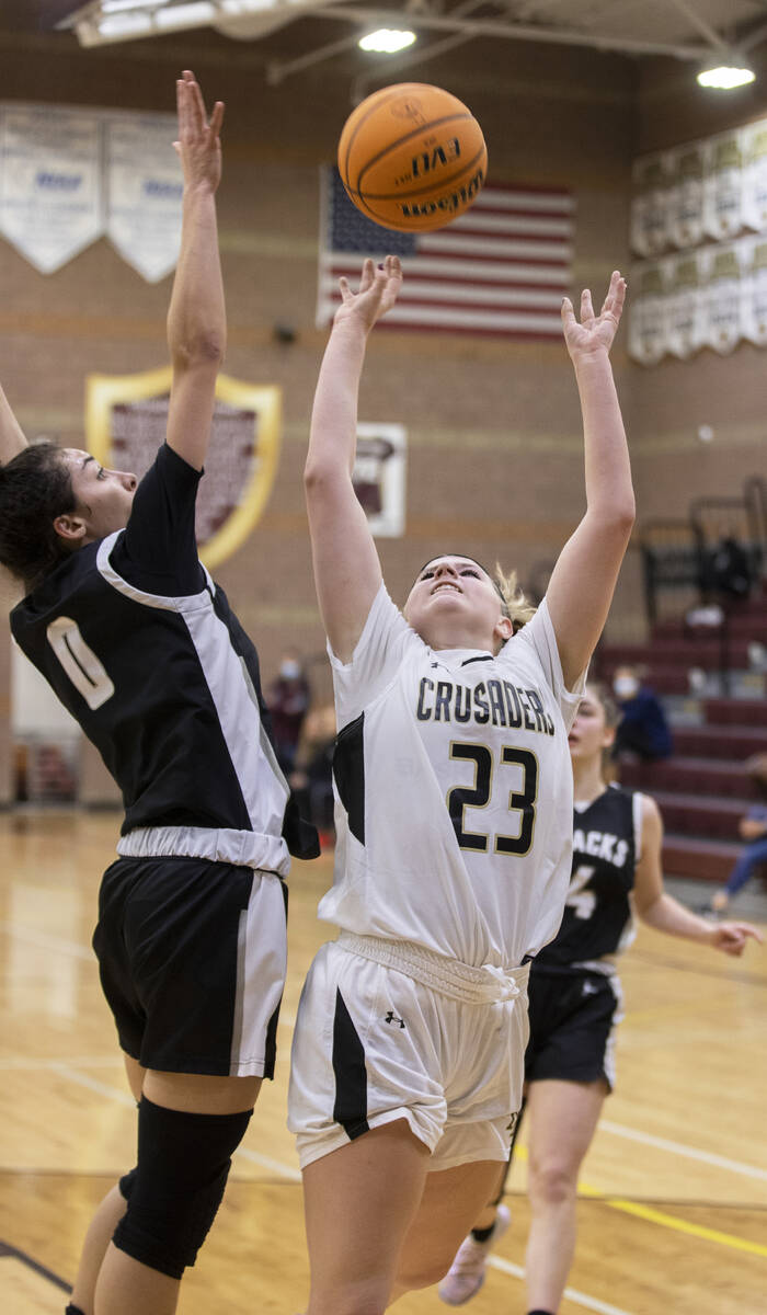 Faith Lutheran’s Raina Forgue (23) fights for a rebound with Desert Oasis’ Olivia ...