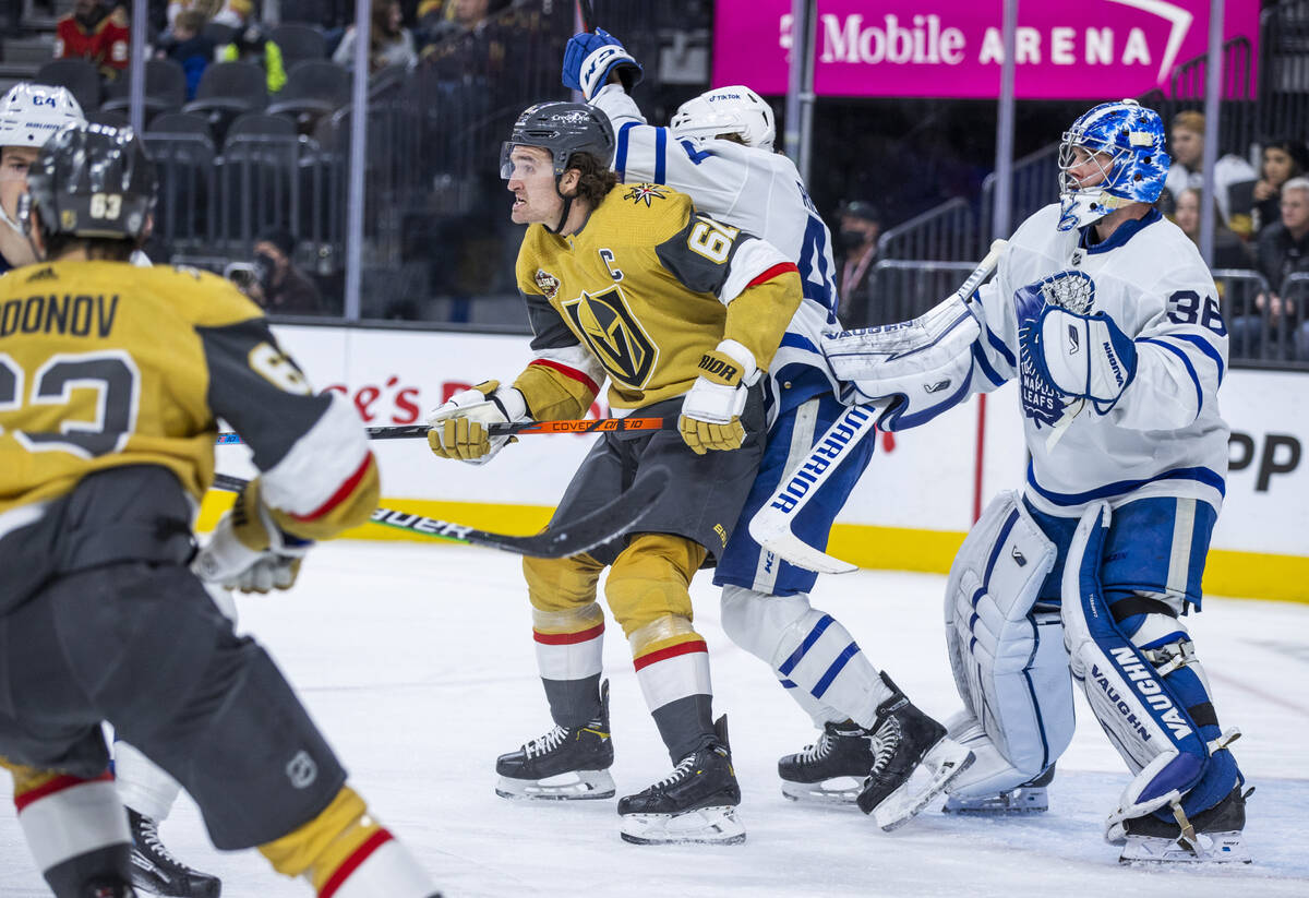 Golden Knights right wing Mark Stone (61) fights for position near the net with Toronto Maple L ...