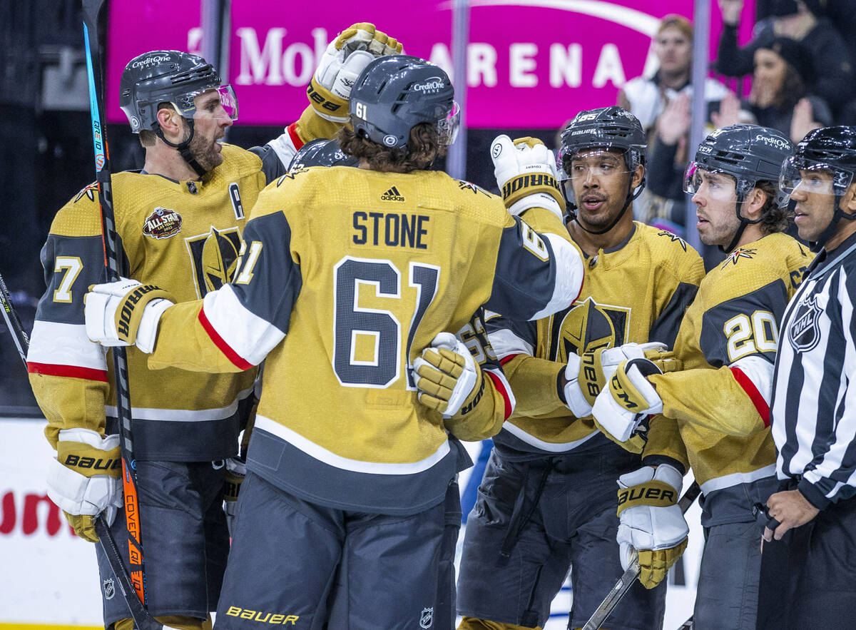 Golden Knights right wing Keegan Kolesar (55) celebrates his goal with right wing Mark Stone (6 ...