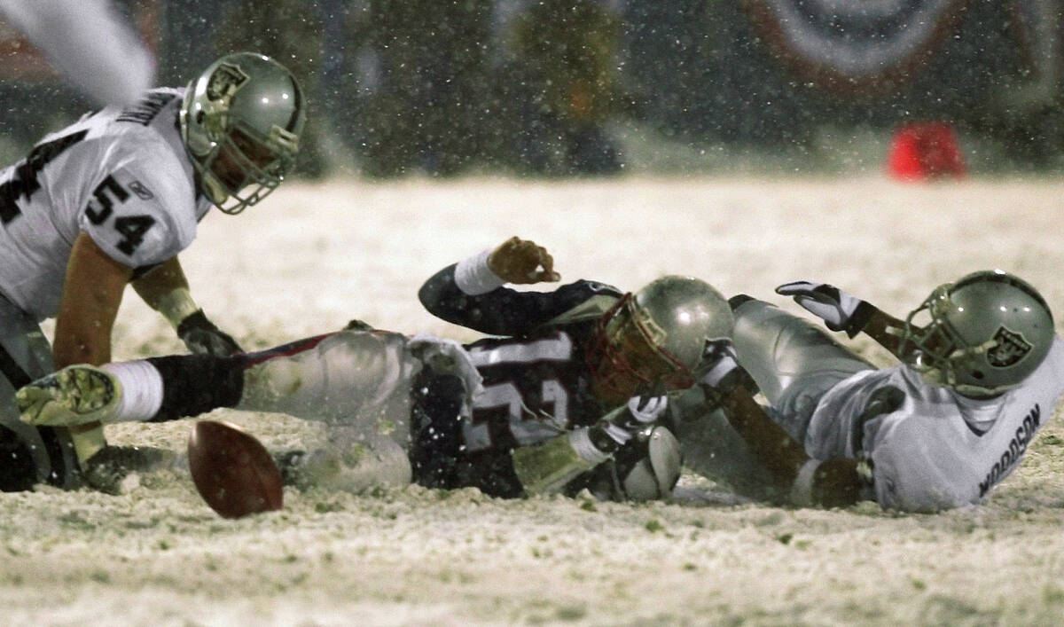 File-New England Patriots quarterback Tom Brady (12) loses the ball after being brought down by ...