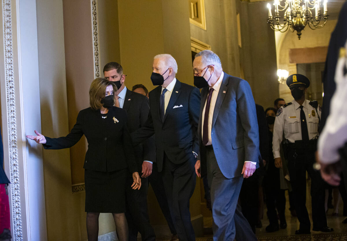 President Joe Biden, center, walks with House Speaker Nancy Pelosi, of Calif., left, and Senate ...