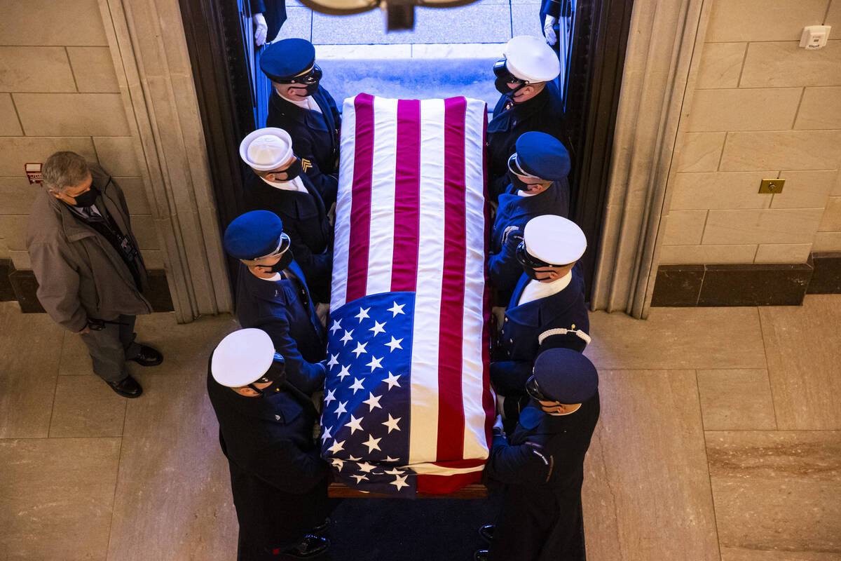 A military honor guard carries the flag-draped casket of former Sen. Harry Reid for departure a ...