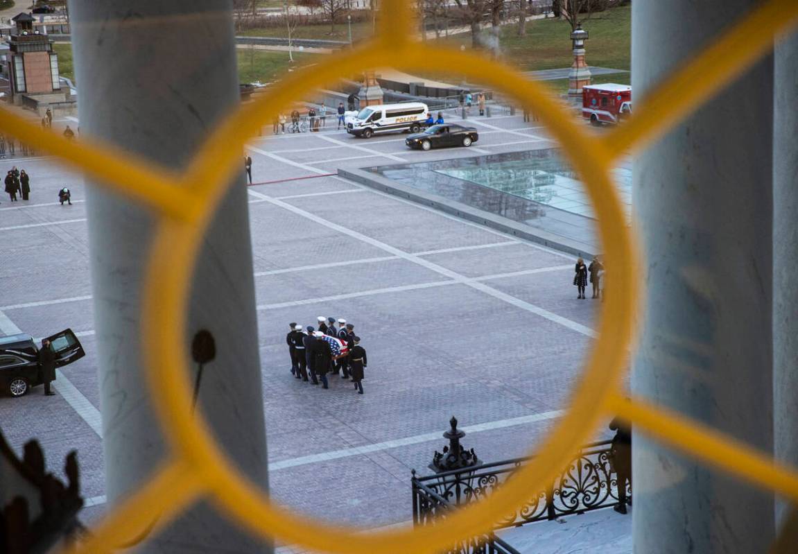 A military honor guard carries the flag-draped casket of former Sen. Harry Reid for departure a ...