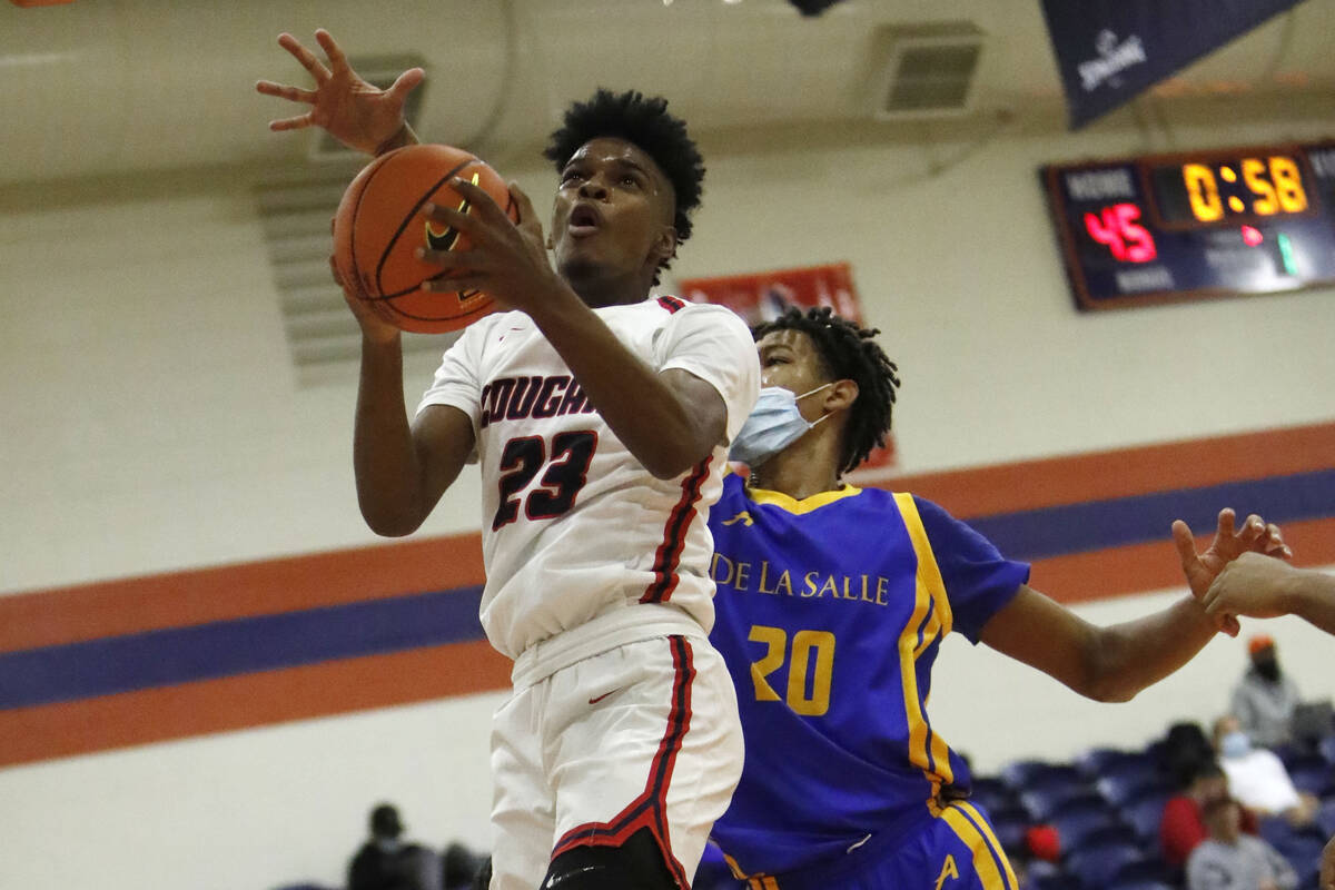 Coronado's Josiah Cunningham (23) shoots over De La Salle's Jamil Wilson (20) in the first half ...