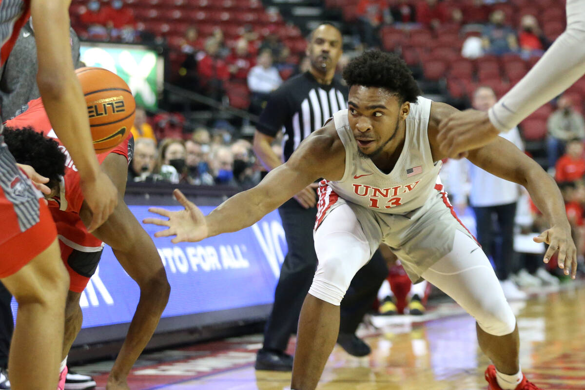UNLV Rebels guard Bryce Hamilton (13) reaches for the ball during the first half of an NCAA col ...