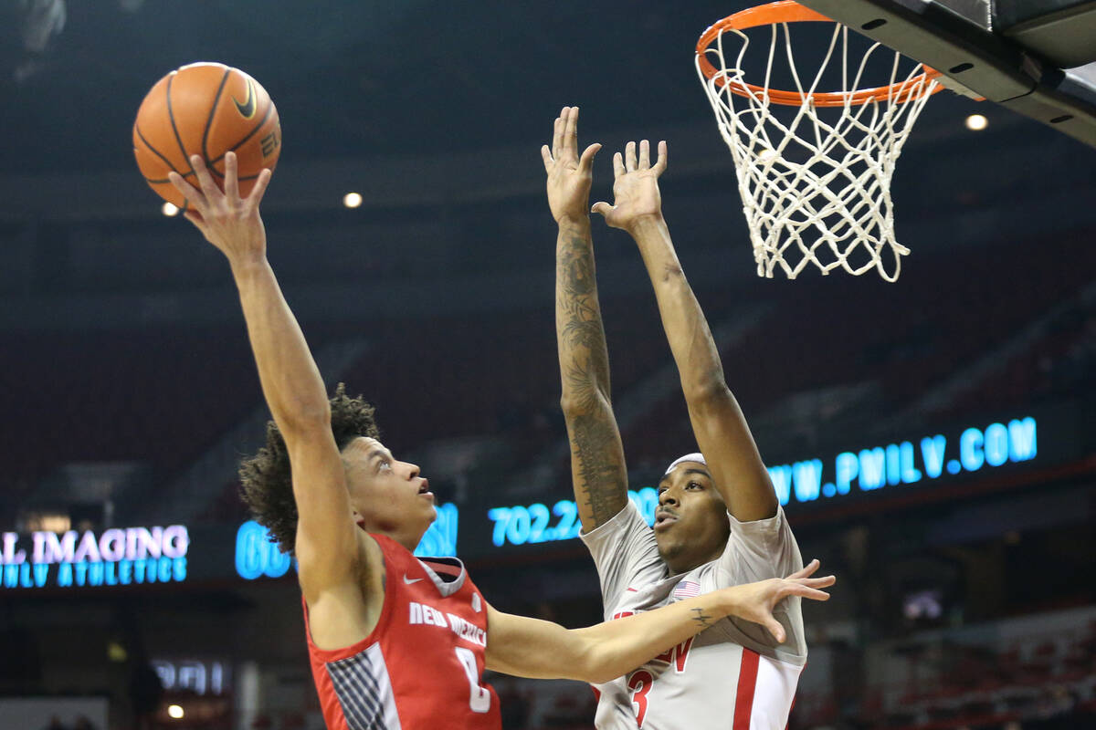 New Mexico Lobos guard KJ Jenkins (0) shoots against UNLV Rebels forward Donovan Williams (3) d ...