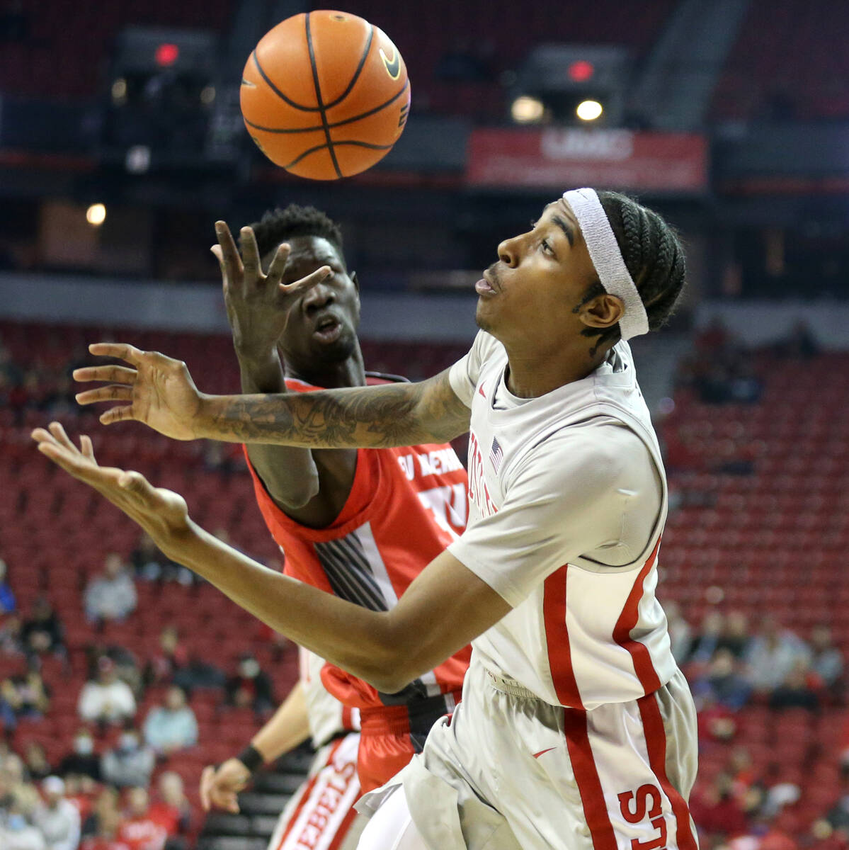 New Mexico Lobos forward Birima Seck (34) loses control of the ball to UNLV Rebels forward Dono ...