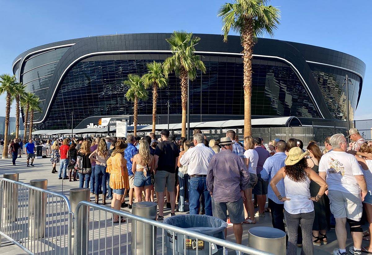 Attendees for a Garth Brooks concert line up at Allegiant Stadium about two hours before the ev ...