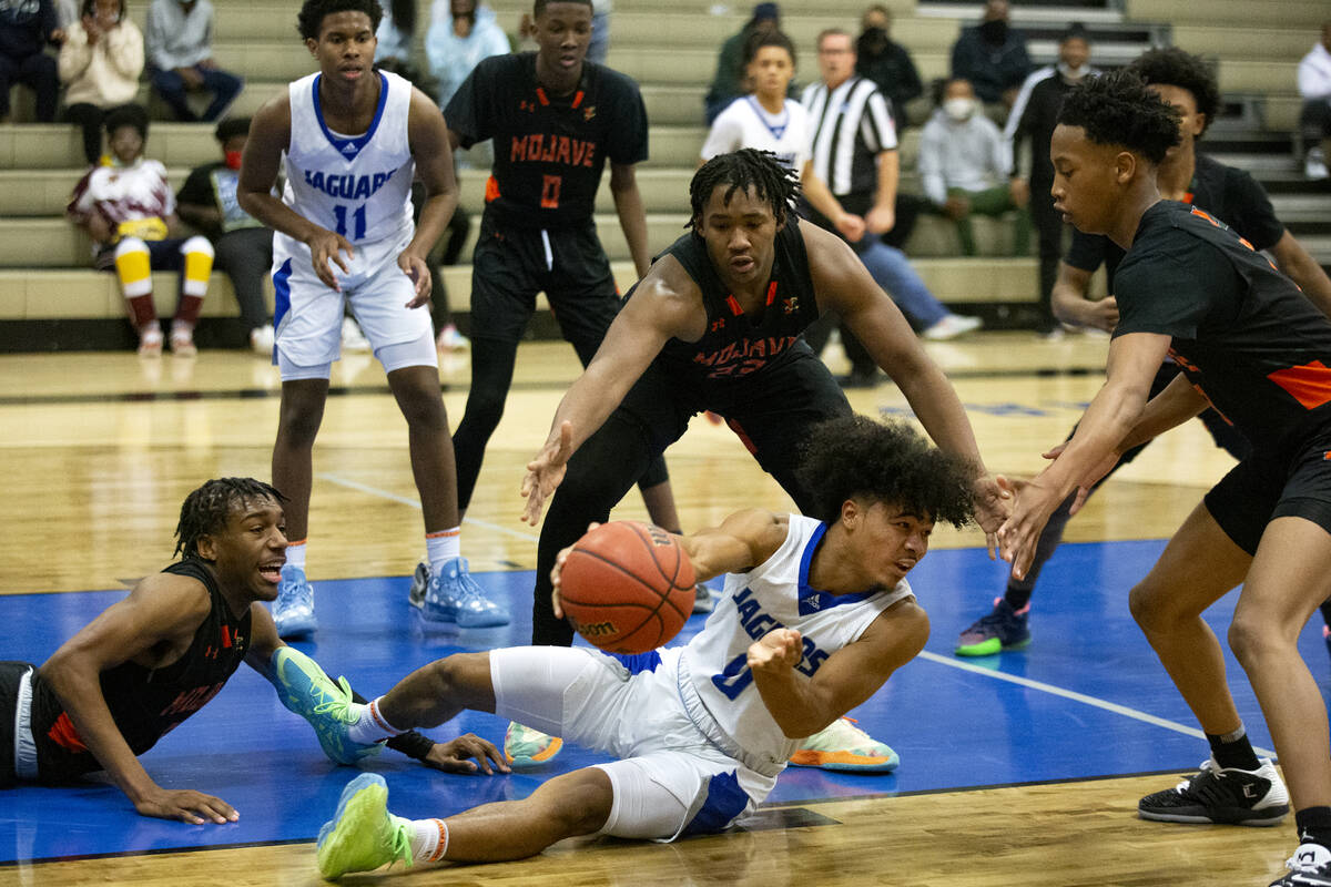 Desert Pines’ Jamir Stephens (0) passes from the court while Mojave’s Jameer McNe ...