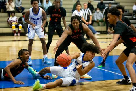 Desert Pines’ Jamir Stephens (0) passes from the court while Mojave’s Jameer McNe ...