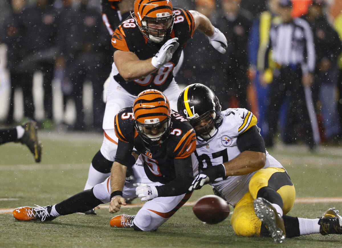 Cincinnati Bengals quarterback AJ McCarron (5) fumbles after being hit by Pittsburgh Steelers' ...