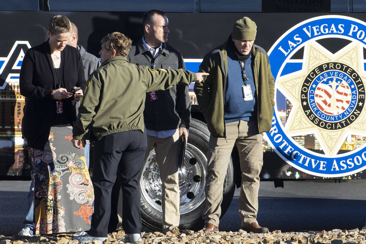 Las Vegas police officers are congregate in the parking lot of a post office at Nellis Boulevar ...