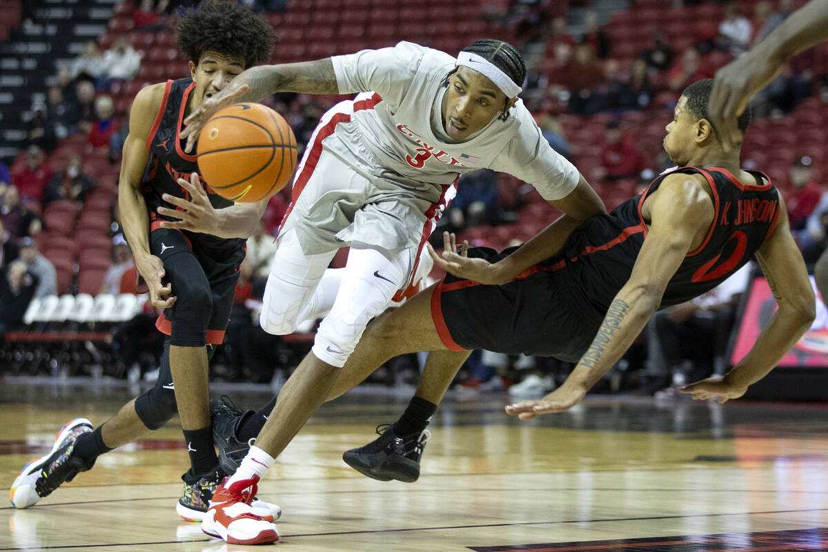 UNLV Rebels forward Donovan Williams (3) drives between San Diego State Aztecs guard Chad Baker ...