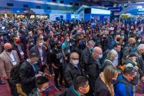Attendees begin to file into the first day of CES during its opening at the Las Vegas Conventio ...