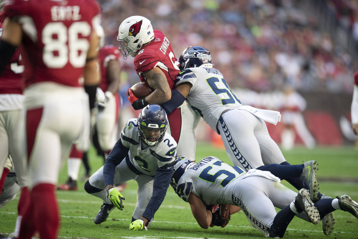Arizona Cardinals running back James Conner (6) is tackled by Seattle Seahawks cornerback D.J. ...