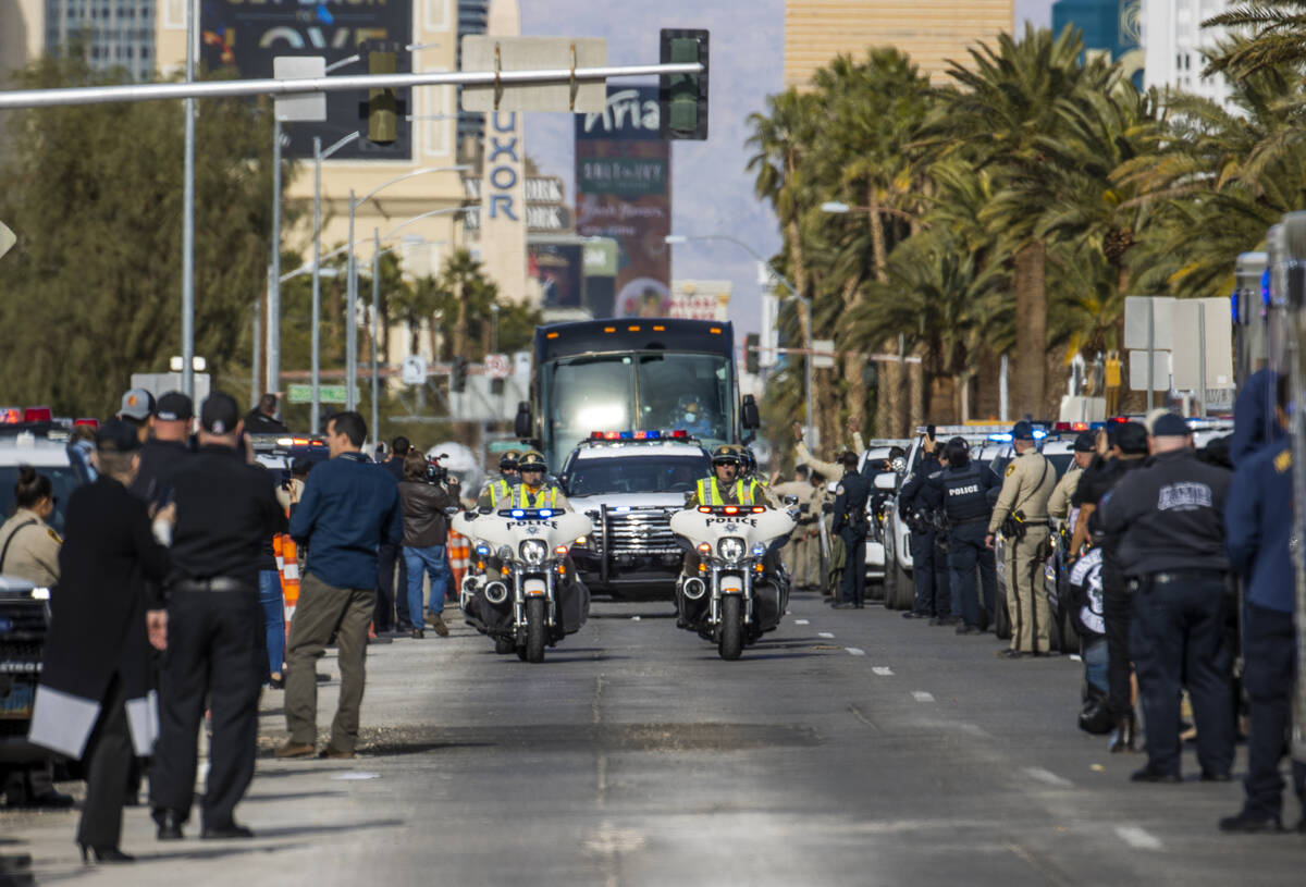 Busses with Raiders players, coaches and personnel are escorted by Metro to depart the city as ...