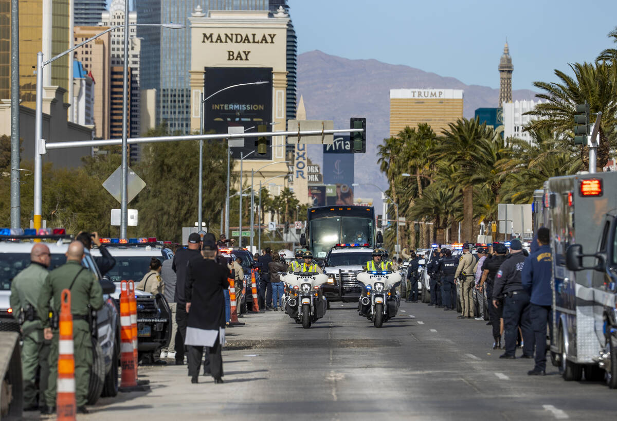 Busses with Raiders players, coaches and personnel are escorted by Metro to depart the city as ...