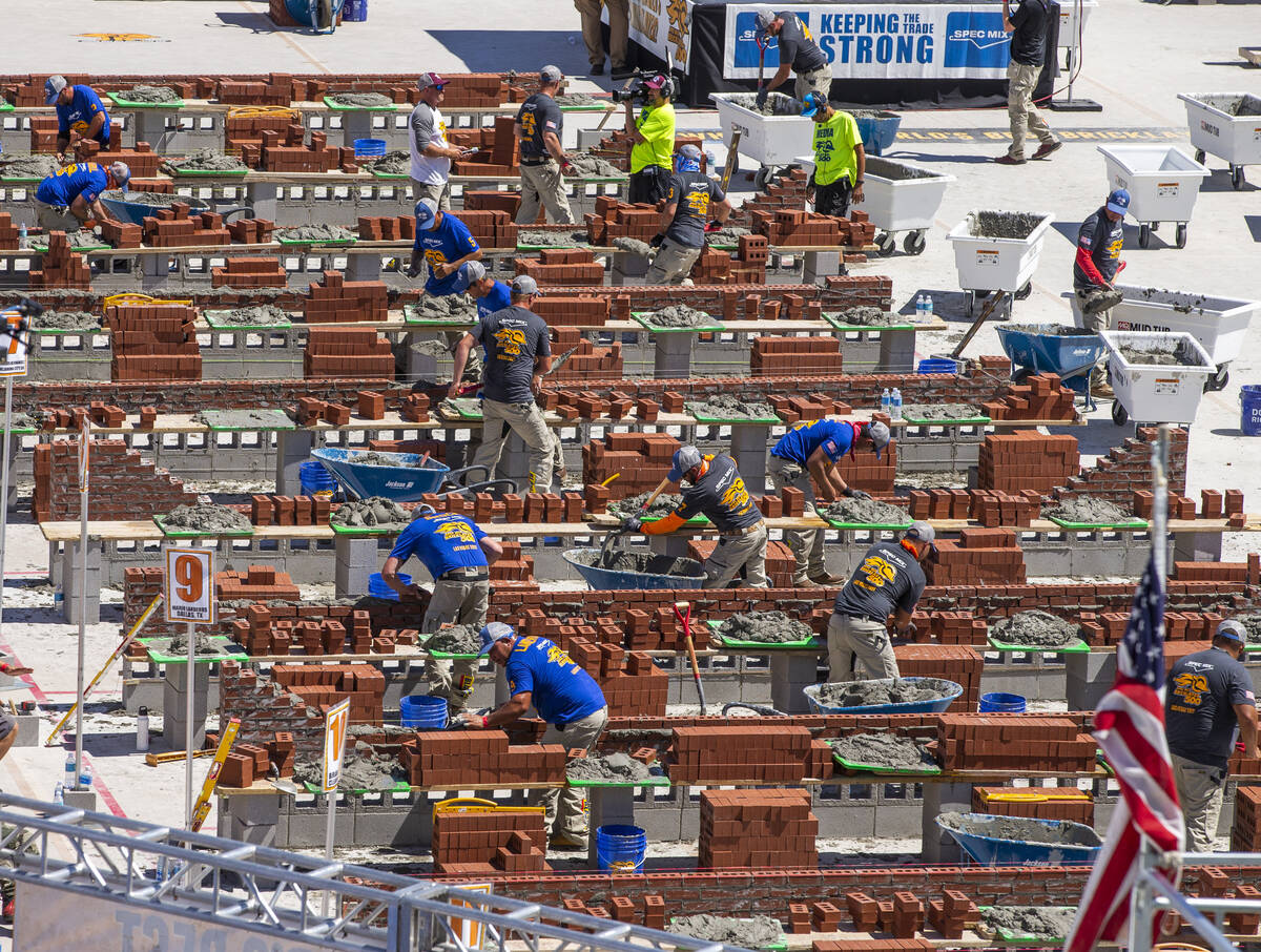 Competitors work their bricks and mortar in the Spec Mix Bricklayer 500 during World of Concret ...