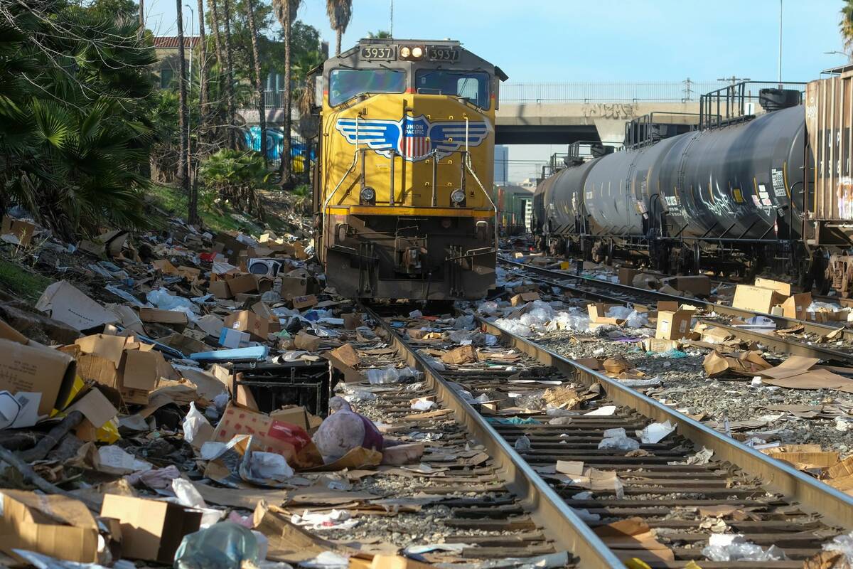 Shredded boxes and packages are seen at a section of the Union Pacific train tracks in downtown ...