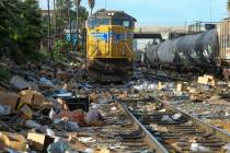 Shredded boxes and packages are seen at a section of the Union Pacific train tracks in downtown ...
