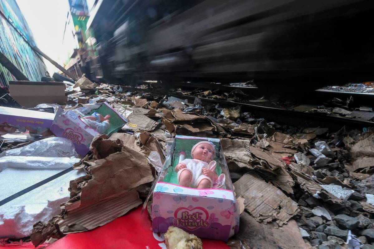 Shredded boxes and packages are seen at a section of the Union Pacific train tracks in downtown ...