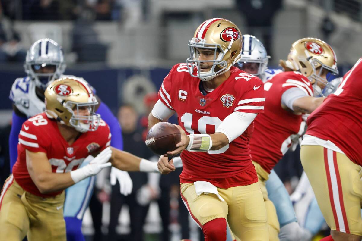 San Francisco 49ers quarterback Jimmy Garoppolo (10) hands off against the Dallas Cowboys durin ...